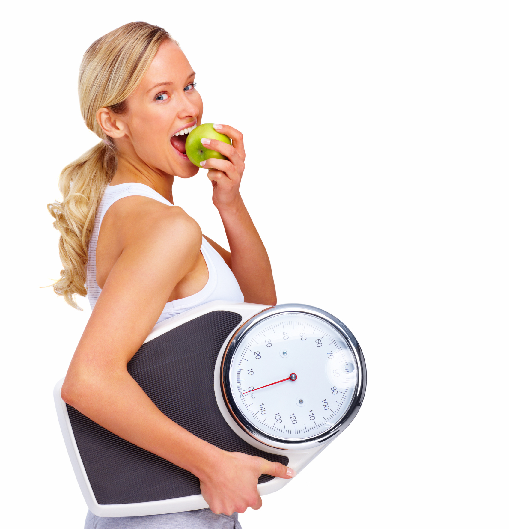 Beautiful young woman holding measuring instrument and eating an apple